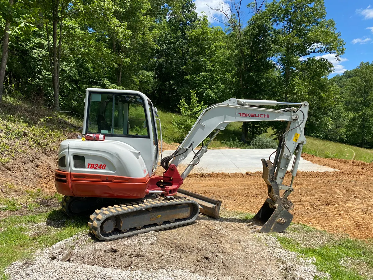 Compact excavator working on a property