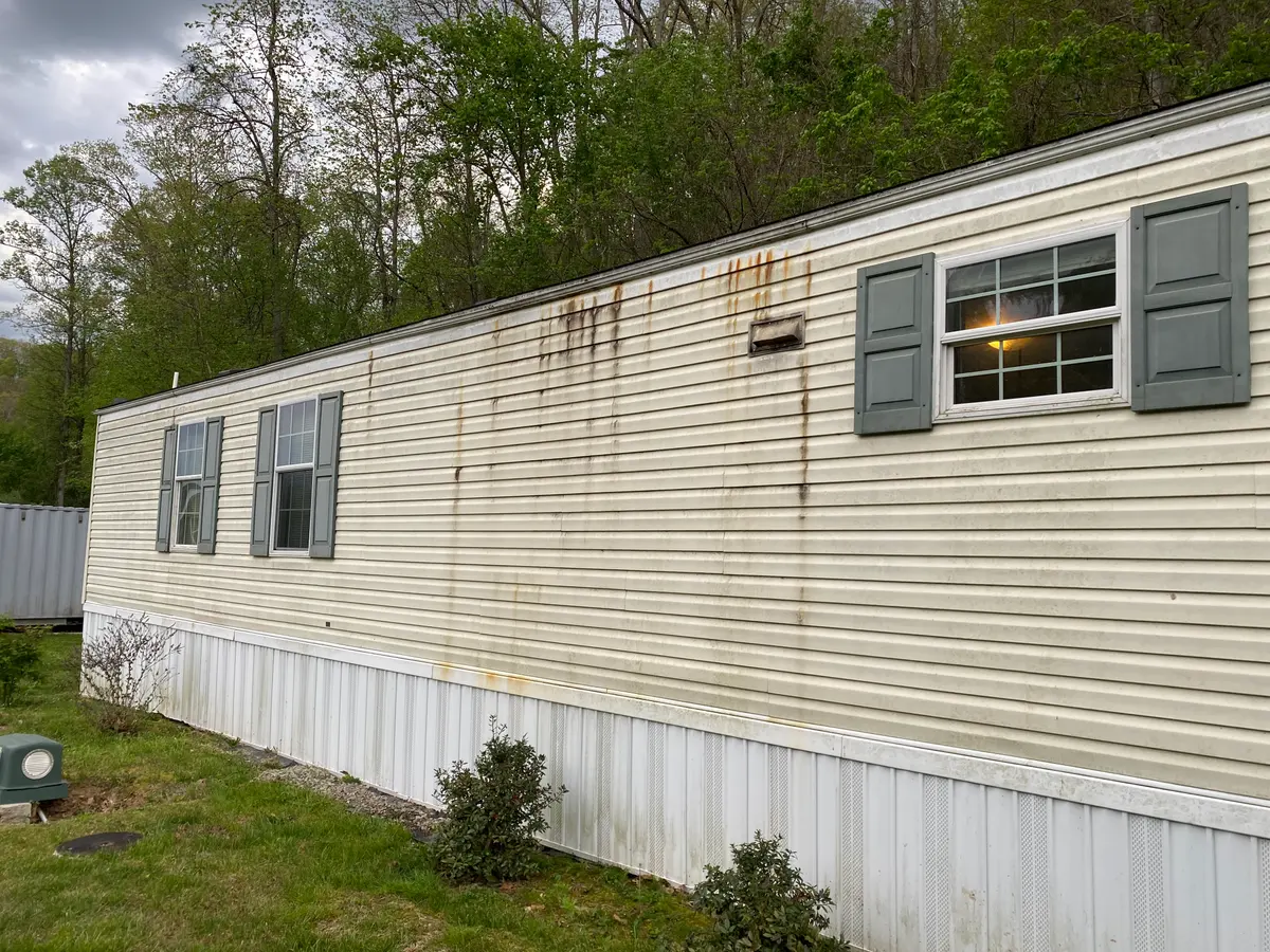 Mobile home exterior before pressure washing